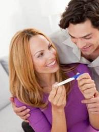How do you get pregnant? A couple has figured it out as they look at the results of their pregnancy test with a smile on their face!